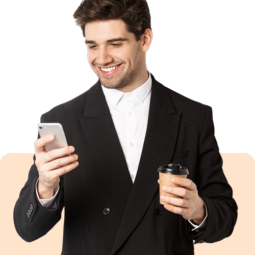 Young businessman with smartphone smiling